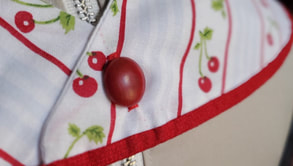 Red button on cherry fabric